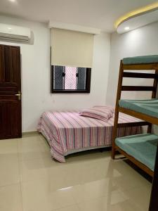 a bedroom with a bunk bed and a window at Apartamento Vista Praia do Anil in Angra dos Reis +24 photos