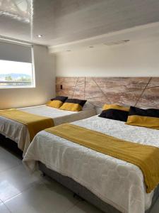 Postel nebo postele na pokoji v ubytování Hotel Funza Real