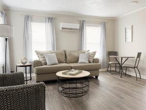 a living room with a couch and a table at Riverside Retreat Apartments in Evansville