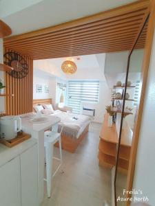 a bedroom with a bed and a desk in a room at Freila's Azure North in San Fernando +32 photos