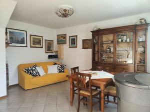 a living room with a yellow couch and a table at Holiday Home in Camaiore near Sandy Beaches in Camaiore