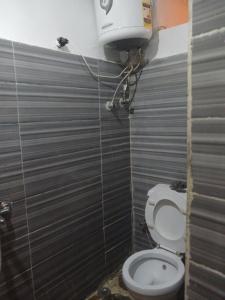 a bathroom with a toilet and a water tank at 7 stars Zamalek in Cairo