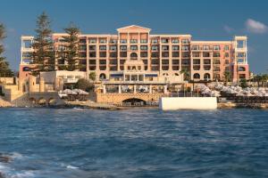 a large hotel on the shore of the water at The Westin Dragonara Resort, Malta in St. Julianʼs
