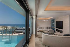 a living room with a swimming pool and a living room at The Westin Dragonara Resort, Malta in St. Julianʼs