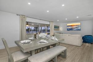 a dining room with a table and a couch at The Waterfront Fishing Retreat in Cape Coral