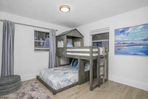 a bedroom with a bunk bed in a room at The Waterfront Fishing Retreat in Cape Coral +17 photos