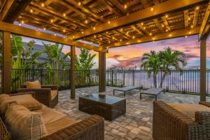 an outdoor patio with furniture and a view of the ocean at The Waterfront Fishing Retreat in Cape Coral