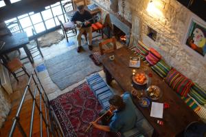 a man sitting at a table in a living room at Anemi in Káto Pediná +37 photos