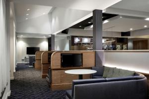 a waiting room with a couch and a table at Courtyard by Marriott Denver Central Park in Denver