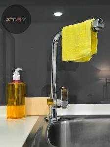 a sink with a bottle of yellow soap next to it at Almas Puteri Harbour Couple Netflix 100mbps BySTAY in Nusajaya