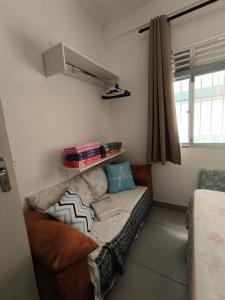 a living room with a couch in a room at Espaço Shalom in Praia Grande