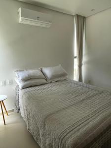 Postel nebo postele na pokoji v ubytování Loft Charmoso com Rooftop no Vila das Dunas