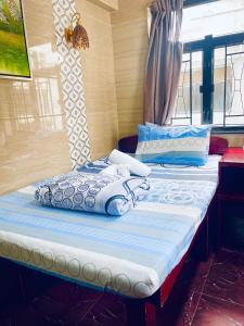 a bedroom with two beds with blue and white pillows at Asia inn (Block B) in Hong Kong +17 photos