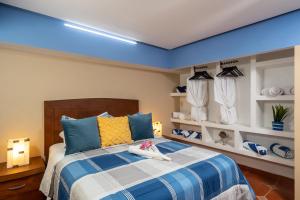 a bedroom with a bed with a blue ceiling at Just Beachy PV in Puerto Vallarta
