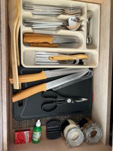 a drawer filled with cooking utensils and other kitchen items at La Casita Aeropuerto Guadalajara in San José del Castillo