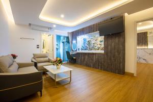 a living room with a couch and a table at Airbus Hotel At Phawana Station in Bangkok