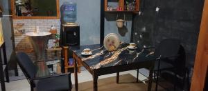 a table and a chair in a room at Araliya Villa in Katunayaka