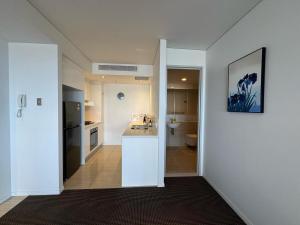 a kitchen with a sink and a counter in a room at Luxury Meriton Suites Retreat in Brisbane