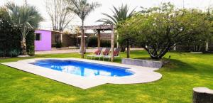 a swimming pool in the middle of a yard at Villas ARVEM 1 in La Sabana