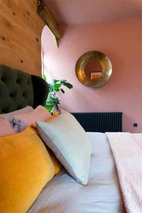 a bedroom with a bed with pillows and a mirror at Old Chapel Llanfrynach in Brecon