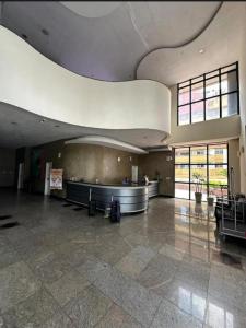 a large lobby with a waiting area in a building at Flat hotel number one 403 in São Luís +24 photos