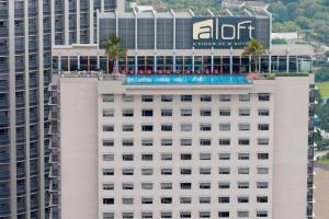 an office building with a pool on top of it at Aloft Kuala Lumpur Sentral in Kuala Lumpur