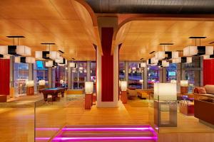 a hotel lobby with a piano and a table at Aloft Kuala Lumpur Sentral in Kuala Lumpur