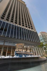 a tall building with a sign in front of it at Aloft Kuala Lumpur Sentral in Kuala Lumpur