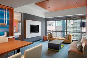 a living room with a couch and a table at Aloft Kuala Lumpur Sentral in Kuala Lumpur