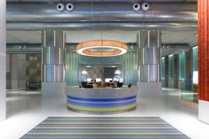 a lobby with a bar in the middle of a building at Aloft Kuala Lumpur Sentral in Kuala Lumpur