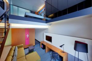 a living room with a couch and a table at Aloft Kuala Lumpur Sentral in Kuala Lumpur