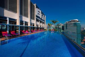 a large swimming pool in front of a building at Aloft Kuala Lumpur Sentral in Kuala Lumpur