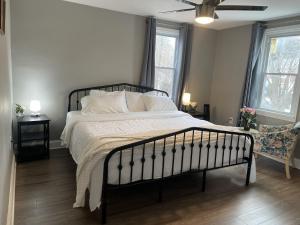 a bedroom with a large bed with white sheets and pillows at Single home, 4 beds, 2 baths in Silver Spring