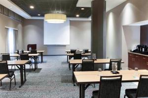a conference room with tables and chairs and a whiteboard at Courtyard Omaha Downtown/Old Market Area in Omaha