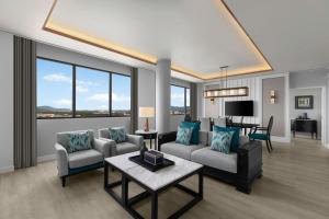 a living room with a couch and chairs and a table at Courtyard by Marriott Phuket Town in Phuket Town