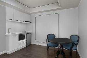 a kitchen with a table and two chairs at Courtyard by Marriott Phuket Town in Phuket Town