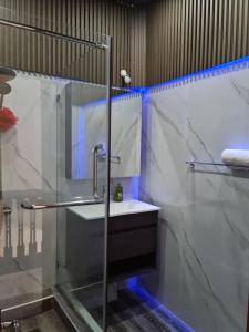 a bathroom with a glass shower and a sink at Bungalow 3 BedRooms, Garden, beach in Flic-en-Flac