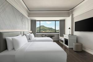 a hotel room with two beds and a large window at Courtyard by Marriott Phuket Town in Phuket Town +37 photos
