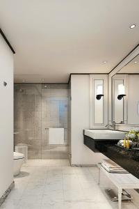 a bathroom with a shower and a sink and a toilet at Courtyard by Marriott Phuket Town in Phuket Town
