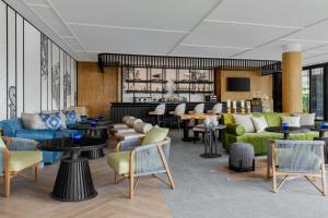 a lobby with couches and tables and a bar at Courtyard by Marriott Phuket Town in Phuket Town