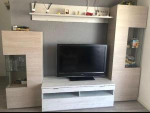 ein Flachbildfernseher auf einem weißen Entertainment-Center in der Unterkunft VILLAS COSETTE Apartamento Neptuno 417 / Confort total en la Costa Brava: WiFi, piscina y aire acondicionado incluidos! - ES-209-90 in Platja  d'Aro