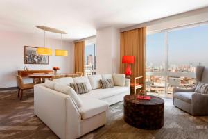 a living room with a white couch and a table at Sheraton Tribeca New York Hotel in New York