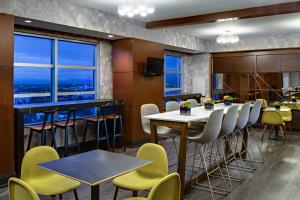 a restaurant with a table and chairs with a view at Renaissance Las Vegas Hotel in Las Vegas
