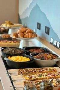 a buffet filled with different types of food on a table at AC Hotel by Marriott San Jose Escazu in San José