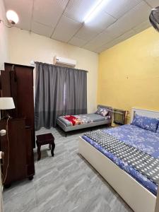 Katil atau katil-katil dalam bilik di Adafea Homestay Jitra
