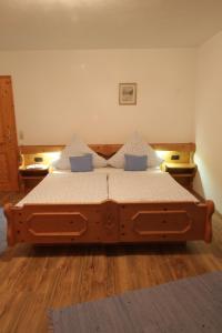 ein Schlafzimmer mit einem großen Holzbett in einem Zimmer in der Unterkunft Ferienhaus Andreas in Krün