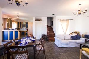 a living room with a table and a couch at Mantilida Villa & Studio in Kissamos