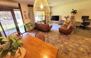 a living room with a table and a couch at Golfers delight in Grange