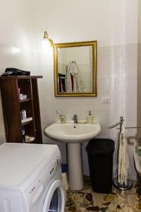 a bathroom with a sink and a washing machine at Casa Macchia in Giarre +22 photos