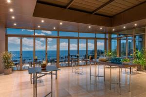 a large room with tables and a view of the ocean at Renaissance Polat Istanbul Hotel in Istanbul